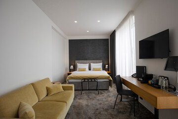 Double bed bedroom hotel room interior in the morning