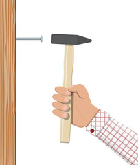 Man hammering nail with hammer into wall