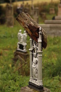 a tombstone overgrown with a tree trunk