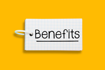 Benefits concept on checkered word card with yellow background 