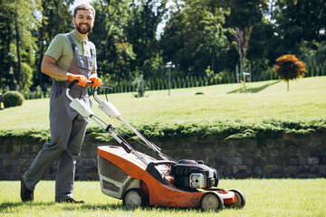 Man gardner cutting grass with lawnmower
