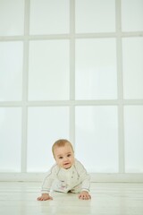 A small newborn baby is in a white room. The concept of childhood