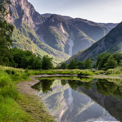 Fototapeta na wymiar Beautiful summer landscape, Scandinavia, Norway. The mountains are reflected in the lake's water