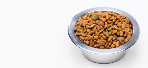 Dry granulated food in a metal bowl for cats and dogs. Animal care, vitamins and balanced pet nutrition.
