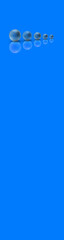 Five balls of metal of different sizes of blue color on blue background. Growth of something. Progress. Reflection. Vertical banner for insertion into site. Place for text cope space