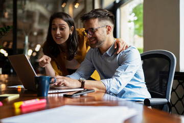 Colleagues working together in the office. Businesswoman and businessman working on the project