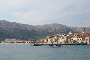 Fototapeta na wymiar View of the harbor and part of the small town of Baska on the island of Krk, Croatia