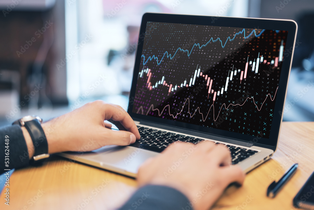 Poster Close up of hands using laptop computer keyboard with forex chart on screen. Bright office desktop background.