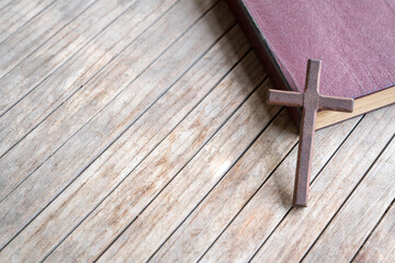 Wooden cross on top of a leather cover bible. Copy space.