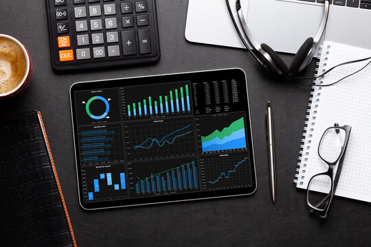 Tablet With Business Reports And Charts