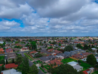 Panoramic aerial Drone view of Melbournes suburbs and CBD looking down at Houses roads and Parks Victoria Australia. Beautiful colours at Sunset