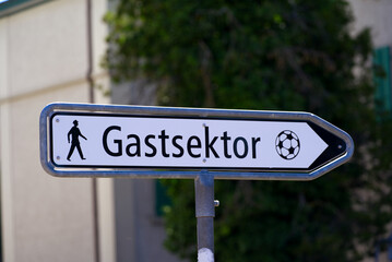 Fototapeta premium Cityscape at City of Winterthur, Canton Zürich, with direction sign to guest area of football stadium Schützenwiese on a sunny summer day. Photo taken July 12th, 2022, Winterthur, Switzerland.