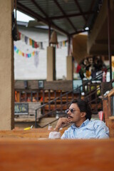 man talking on cellphone in cafe