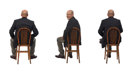 back view of a man sitting on chair and looking at camera on white background