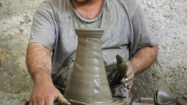 4K Footage of ceramic manufacture mam making handcrafted potteryn in a factory. Pot throwing and painting. Moroccan pottery production. Ceramics is traditional industry in Fez