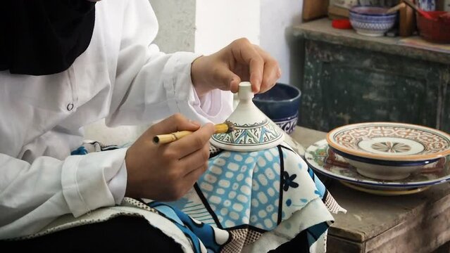 4K Footage of ceramic manufacture, man making handcrafted pottery. Painting traditional Moroccan pottery. Ceramics is traditional industry in Fez