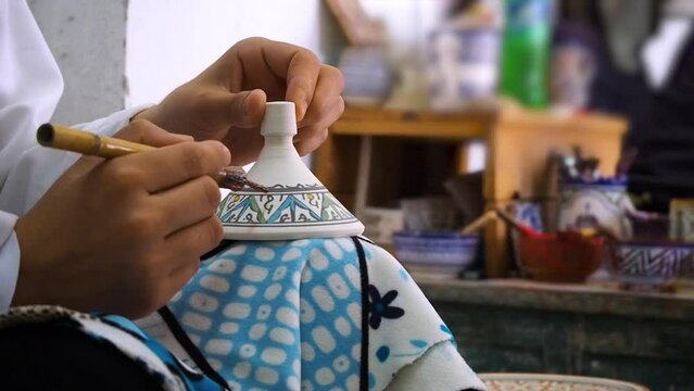 4K Footage of ceramic manufacture man making handcrafted pottery in a factory. Pot throwing and painting. Moroccan pottery production. Ceramics is traditional industry in Fez