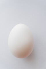 Close up view of organic chicken egg on white background.