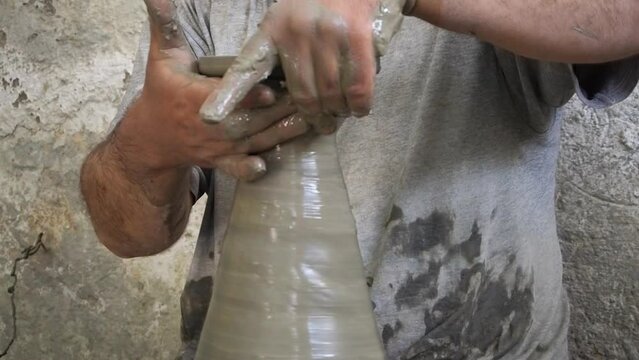 4K Footage of ceramic manufacture man making handcrafted potteryn in a factory. Pot throwing and painting. Moroccan pottery production. Ceramics is traditional industry in Fez