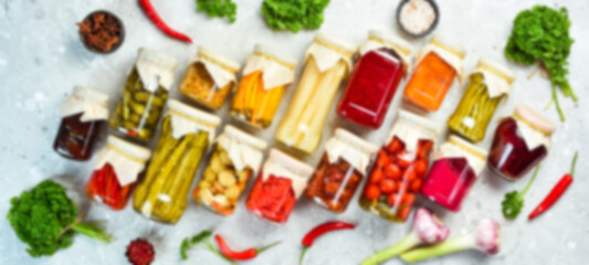 Defocused food background. Set of pickled food stocks in cans. Top view. Free space for your text.