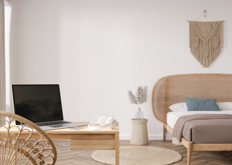 Laptop and headphones on table at home. Distance education, courses, online training, learning concept. Work from home, working online. Shopping via internet. E-commerce. Modern interior. 3D render.