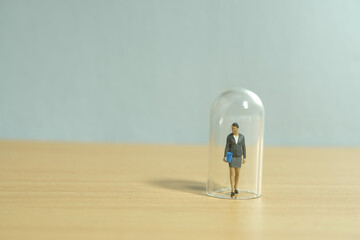 Miniature people toy figure photography. Women limitation concept. A businesswoman standing in the...