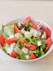 Delicious fresh Greek salad with tomato, cucumber, sweet pepper and feta cheese