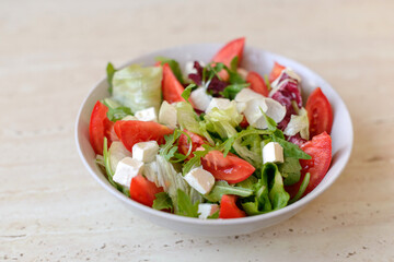 Delicious fresh Greek salad with tomato, cucumber, sweet pepper and feta cheese