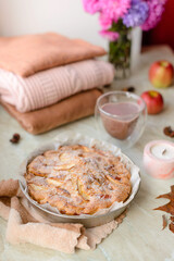 Homemade apple pie on a white background near the window close-up and copy space
