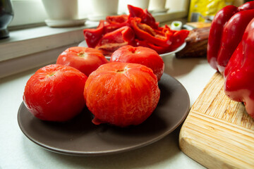 Scalded peeled red tomatoes on a plate as an ingredient