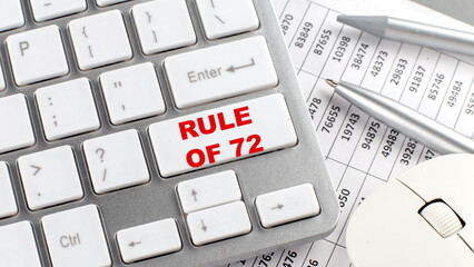 RULE OF 72 text on a keyboard wirh chart and pencil