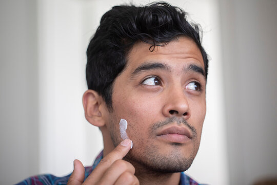 Man applying face cream