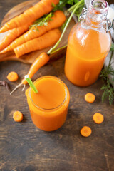 Healthy food concept, fresh natural juice. Glass jar of fresh carrot juice with fresh carrots on a rustic table. Copy space.