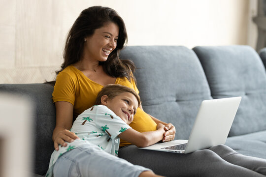 Son put his head on pregnant moms belly while she works