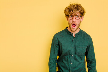 Young caucasian man isolated on yellow background shouting very angry, rage concept, frustrated.