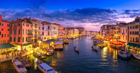 Evening panorama of the Grand Canal filled with lights in Venice, Italy. Summer holidays. Travel concept background.