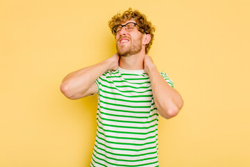 Young caucasian man isolated on yellow background suffering neck pain due to sedentary lifestyle.