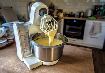 Kitchen robot (food processor) mixer in the process of making cake cream.
