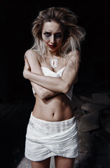 Strange crazy girl in bandages. Morbid sad young woman (freak) with messy make-up. Portrait of...