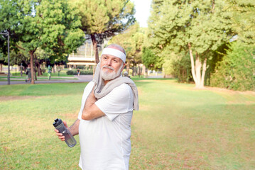 senior man sweating and taking a break after exercising in the park