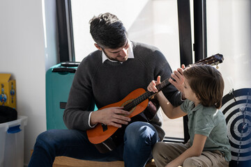 Father and son moments 
Father playing with his son in his room