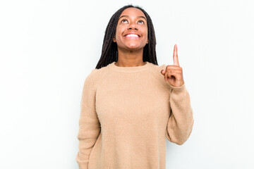 Young African American woman isolated on white background indicates with both fore fingers up...
