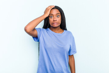 Young African American woman with braids hair isolated on blue background being shocked, she has remembered important meeting.