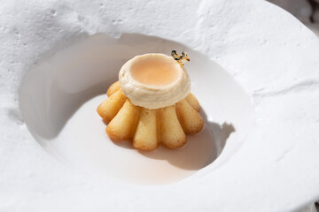Muffin cake with cream in a white plate