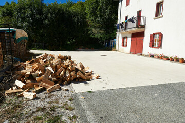 rural country house with cement floor and freshly cut stacked firewood