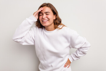 Young caucasian woman isolated on blue background joyful laughing a lot. Happiness concept.