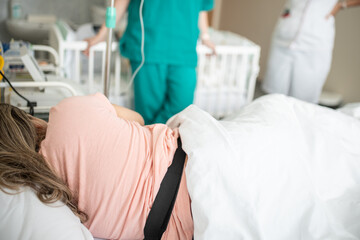 In the Hospital Woman Giving Birth Support by her Husband. Modern Delivery Ward. Painless Childbirth