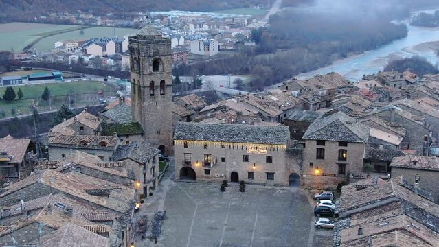 aerial shot at dusk over the medieval town of Ainsa and in whose foreground is the tower. It is located in Huesca in the province of Aragon.