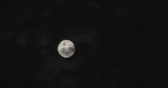 Time Lapse of Full moom moving across clouds in the dark night, Mystic Concept