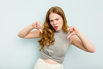 Young caucasian woman isolated on blue background feels proud and self confident, example to follow.